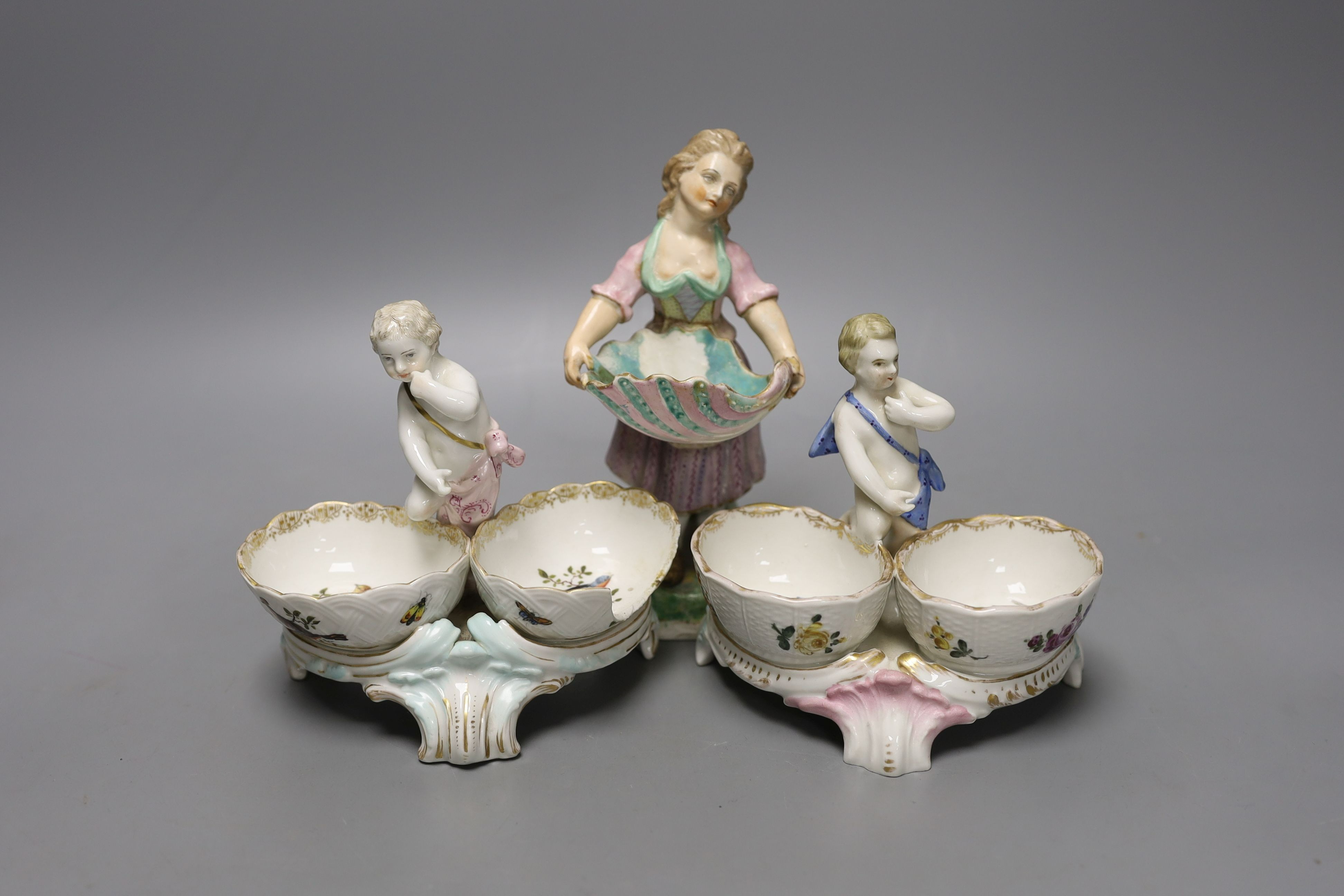 Two 19th century German porcelain putti salts and a Sampson Hancock, Derby figurine holding a shell (3) - tallest 17.5cm